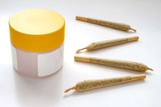 A Cannabis white and yellow plastic packaging container with Cigarettes, Prerolls or Joints and a on a white background