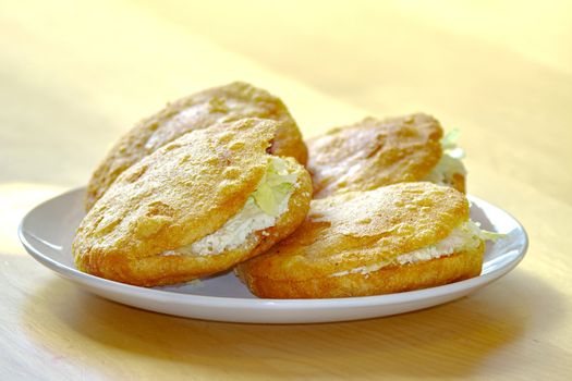 A Gordita "chubby" in Spanish is a Mexican cuisine is a pastry made with maize dough and stuffed with cheese, meat, or other fillings.