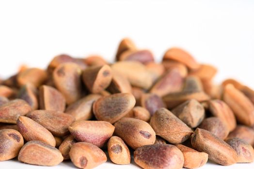 Pine nuts closeup. Cedar nuts on white background