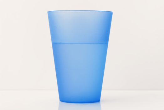 Plastic glass. Plastic cup with water on white background.