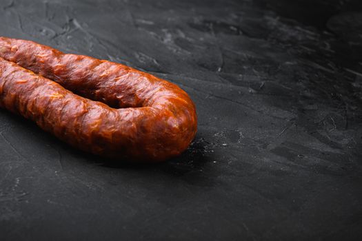 Spanish pork chorizo sausages on black background with space for text.