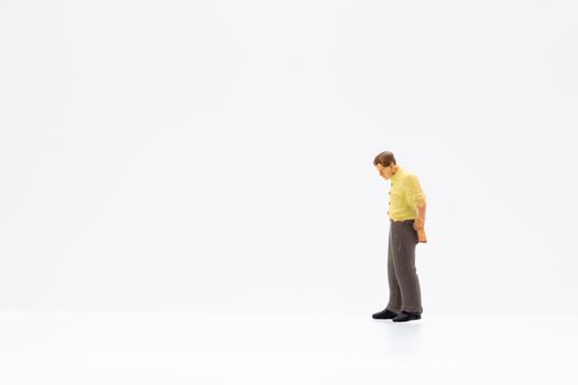 Miniature people standing on white background and space for text
