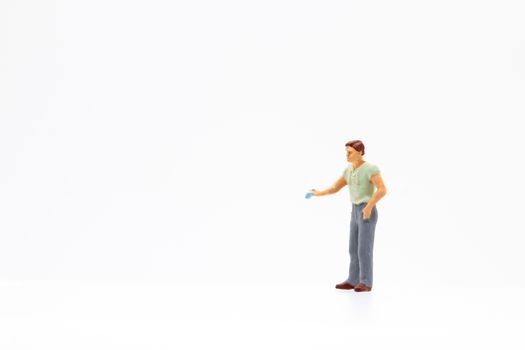 Miniature people standing on white background and space for text