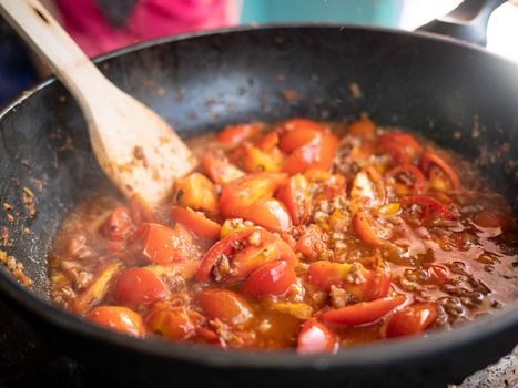 Famous food in the north of Thailand. The main components are tomatoes and pork. Close-up of tomatoes in red curry paste (Nam Prik Ong) in pan.