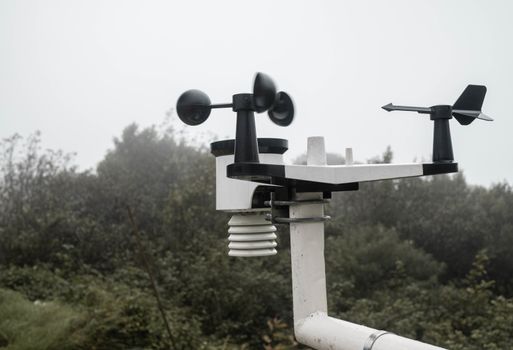 The Meteorological instrument to measure the wind speed, temperature and humidity and solar cell system on peak of Inthanon mountain.