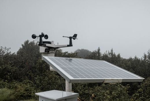 The Meteorological instrument to measure the wind speed, temperature and humidity and solar cell system on peak of Inthanon mountain.