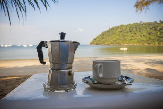 Drinking coffee on the beach in paradise of Koh Phayam, Ranong, Thailand.