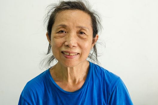 Asian female senior portrait on background.