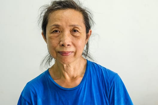 Asian female senior portrait on background.