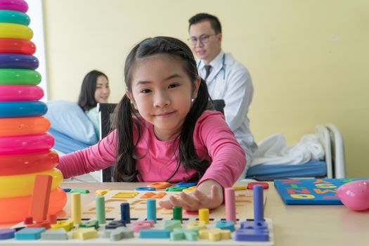 Asian preschool girls do learning and development activities. For children at the clinic. Doctor background for physical examination and consultation of female patients in the clinic
