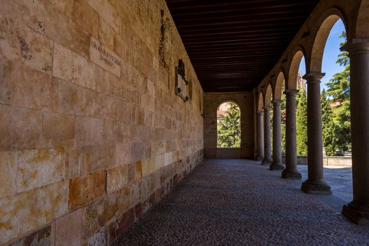Salamanca, Spain - April, 28, 2019: Old historic cloister in the downtown of Salamanca. Plateresque XV century. The old city of Salamanca was declared a UNESCO World Heritage site in 1988.