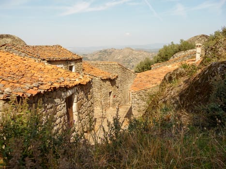 Old and historical houses in the village of Monsanto, Portugal, with views over the landscape and valley.