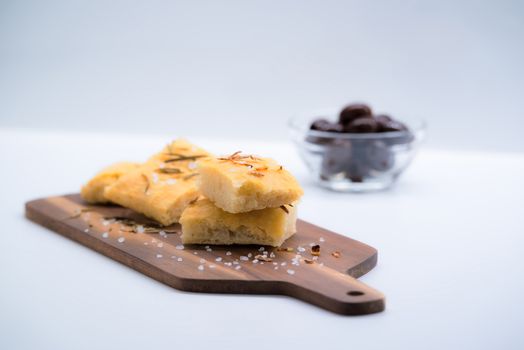 Italian focaccia with onion over a cutting board