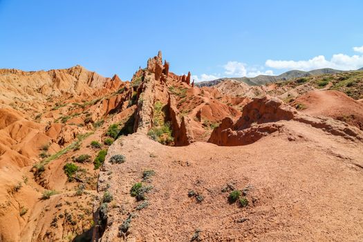 Red sandstone rock formations Seven bulls and Broken heart, Jeti Oguz canyon in Kyrgyzstan, Issyk-Kul region, Central Asia