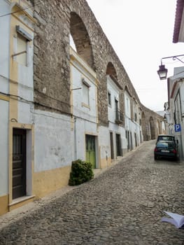 Evora, Portugal, October 2010: Houses built in the arches of Aqueduto da agua de Prata in Evora, Portugal