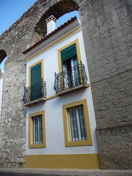 Evora, Portugal, October 2010: Houses built in the arches of Aqueduto da agua de Prata in Evora, Portugal