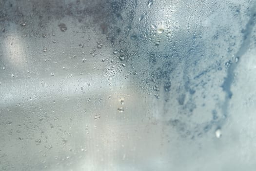 Bright grey color glassy texture, with water drops on it: abstract background