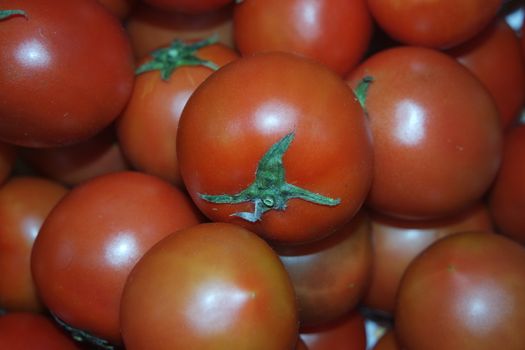 Close-up view of red tomatoes in market for sale. A fruit background for text and advertisements