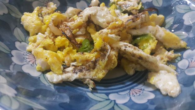Closeup view of fried egg omelet dish in a fry pan. Home made egg omelet is served in breakfast.