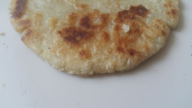 Closeup view of of traditional bread called Jawar roti or bhakri on white background. Bhakri is a round flat unleavened bread often used in the cuisine of many Asian countries
