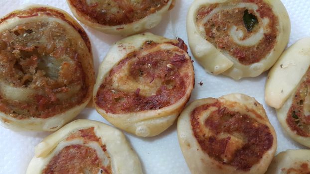 Closeup of delicious home made pinwheel puff pastries food item placed over white background