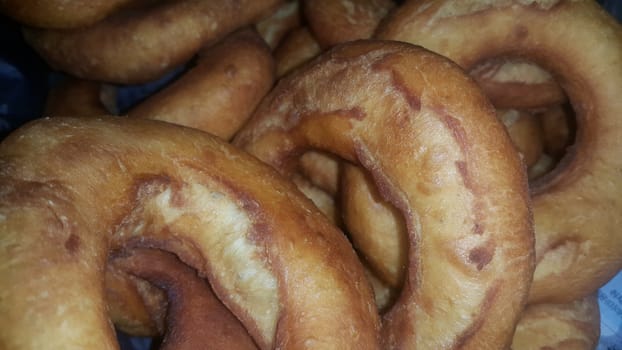 Closeup view of a set of freshly prepared donuts. Donuts are brown color and tasty food