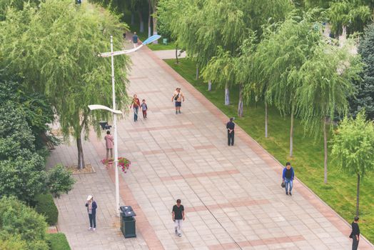 Harbin, Heilongjiang, China - September 2018: Street with green trees. View of a pedestrian street.