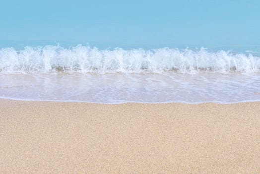 Wave of blue sea on sandy beach. Sea surface background.