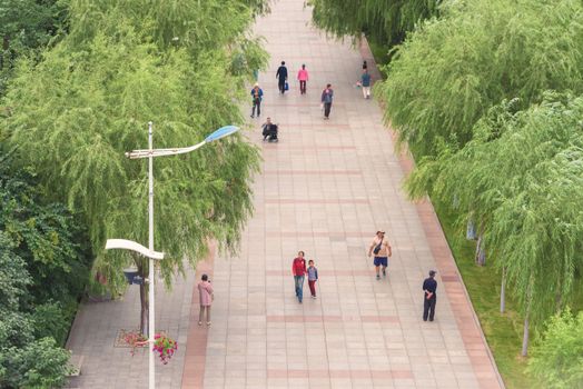 Harbin, Heilongjiang, China - September 2018: Street with green trees. View of a pedestrian street.