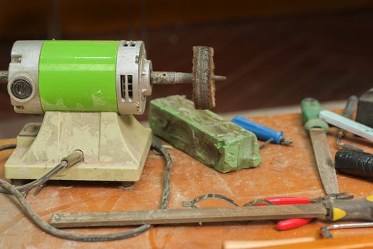 Grinding machine and bench tool on the workbench. Workplace and tools locksmith