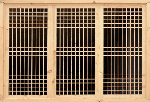 Wooden lattice on the window. Lattice window frame