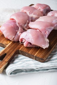 Skinless chicken thighs on white background.