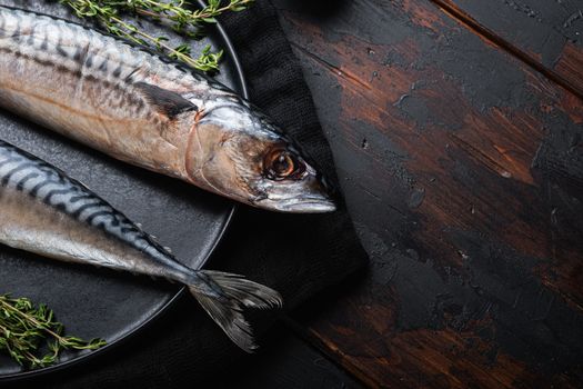 Mackerel with ingredients on wooden table with space for text.