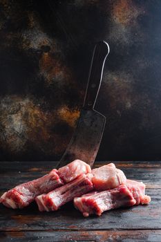 Fresh raw pork meat from organic farm over rustic wood and metal background side view.