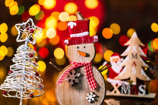 Decorations and ornaments in a colorful Christmas composition isolated on background of blurred lights.