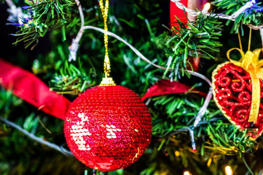 Christmas hanging decorations on fir tree. Decorated Christmas tree. Fir branch with Christmas baubles decorations.