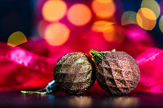 Decorations and ornaments in a colorful Christmas composition isolated on background of blurred lights.