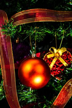 Christmas hanging decorations on fir tree. Decorated Christmas tree. Fir branch with Christmas baubles decorations.