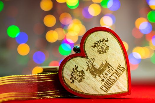 Decorations and ornaments in a colorful Christmas composition isolated on background of blurred lights.