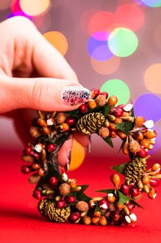 Colorful decorated Christmas wreaths isolated on background of blurred lights.