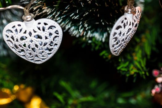 Christmas hanging decorations on fir tree. Decorated Christmas tree. Fir branch with Christmas baubles decorations.