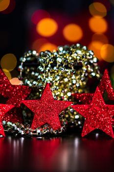 Decorations and ornaments in a colorful Christmas composition isolated on background of blurred lights.