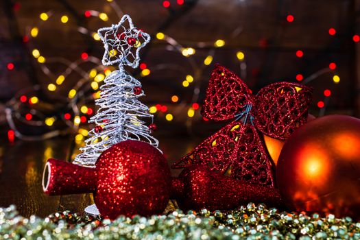 Decorations and ornaments in a colorful Christmas composition isolated on background of blurred lights.