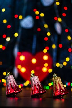 Decorations and ornaments in a colorful Christmas composition isolated on background of blurred lights.