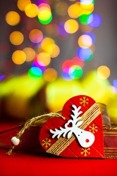 Heart shaped Christmas decoration isolated on blurred background of lights.