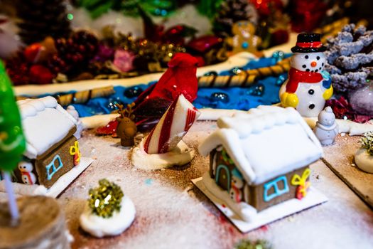 Colorful gingerbread house isolated on blurred background with Christmas decoration.