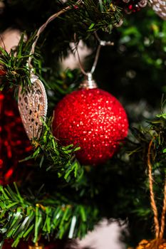 Christmas hanging decorations on fir tree. Decorated Christmas tree. Fir branch with Christmas baubles decorations.