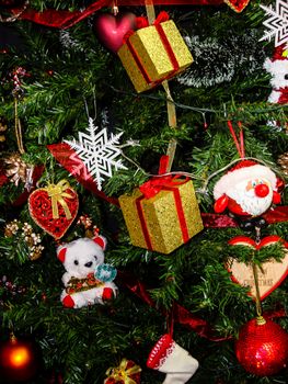 Christmas hanging decorations on fir tree. Decorated Christmas tree. Fir branch with Christmas baubles decorations.