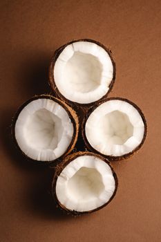 Coconut fruits on brown plain background, abstract food tropical concept, top view