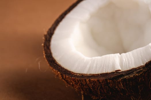 Coconut fruits on brown plain background, abstract food tropical concept, angle view macro